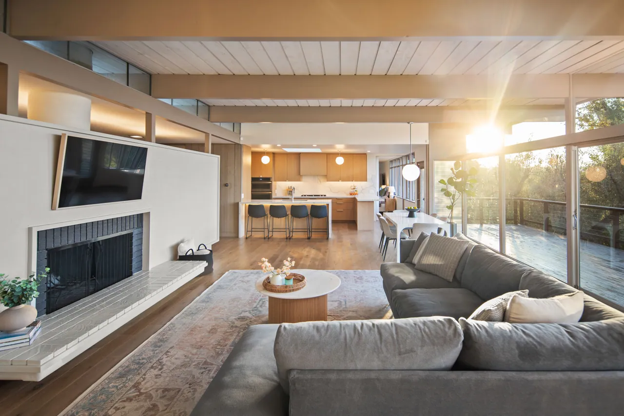 Living room with brick fireplace and low sun through the clerestory