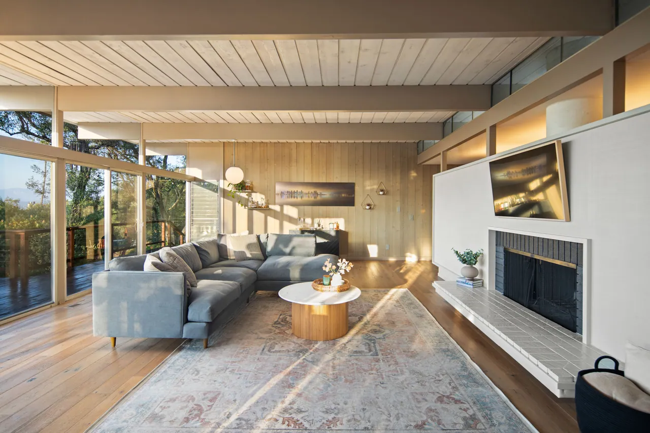 Living room with fireplace and floor-to-ceiling glass