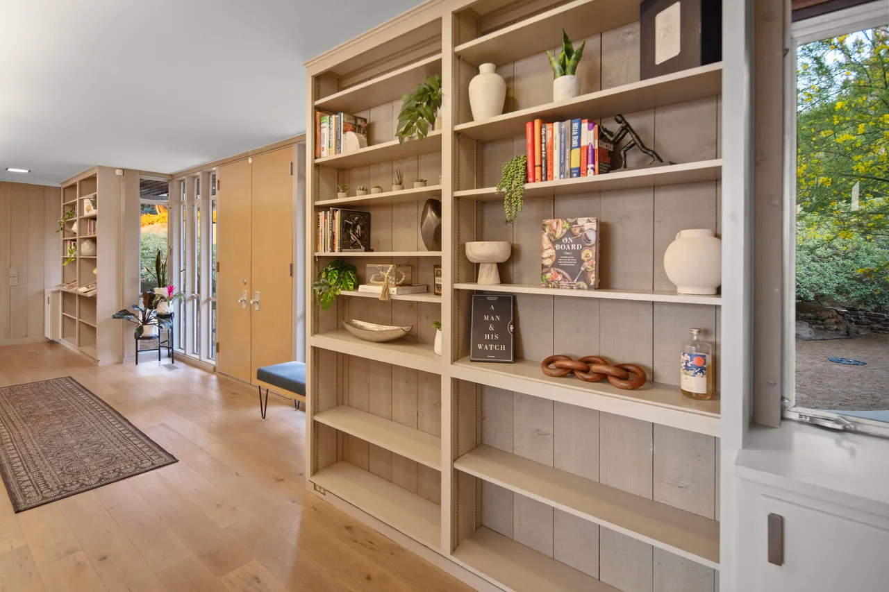 Built-in oak bookshelves along the hall