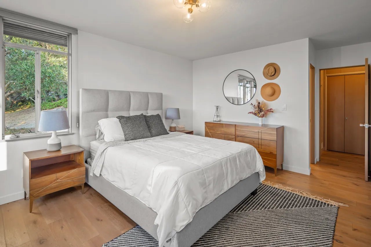 Primary bedroom with a dresser and garden windows