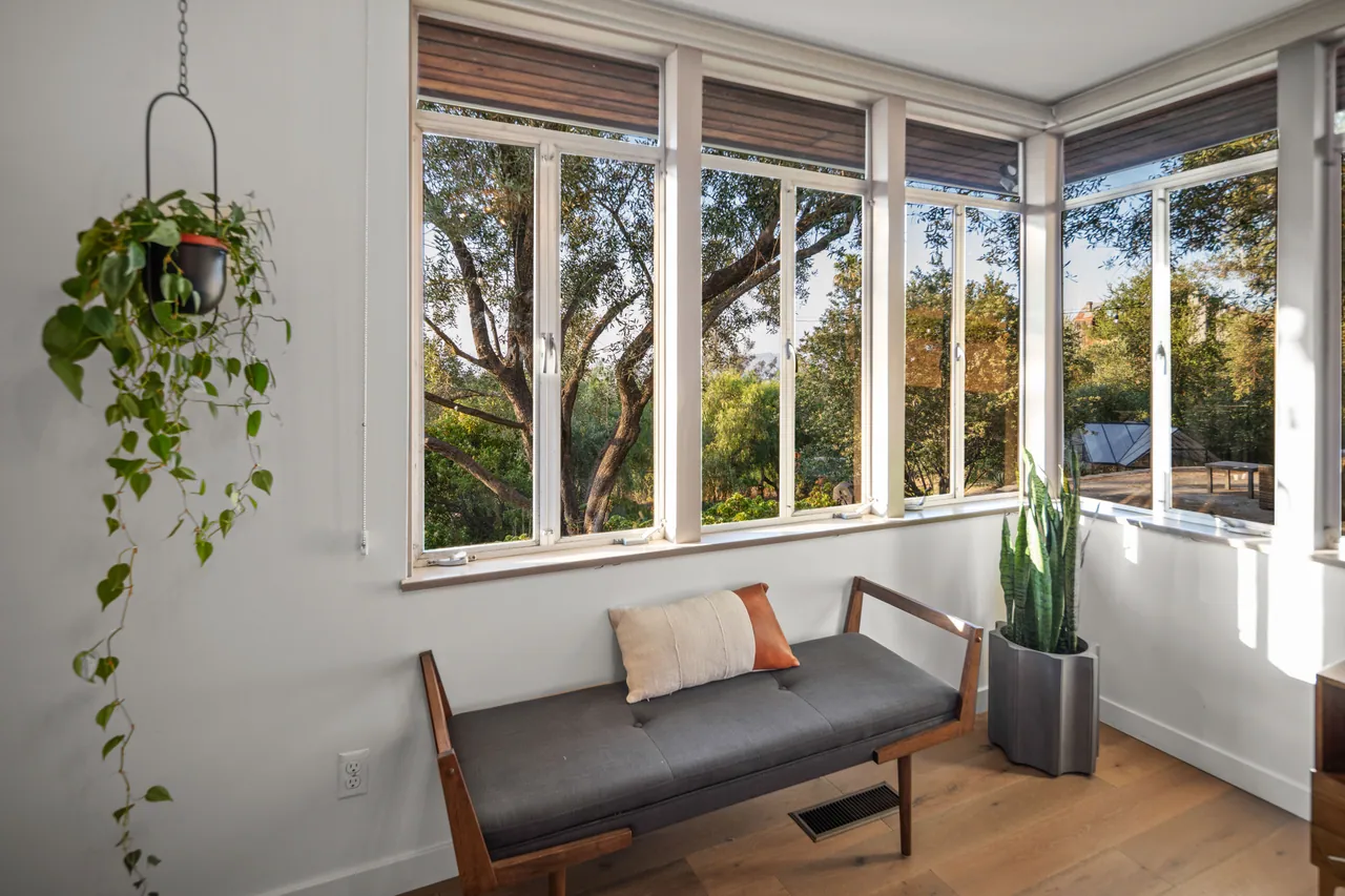 Window corner with a bench and hanging plant