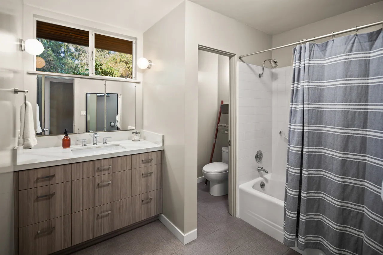 Primary bath with wood vanity and tub