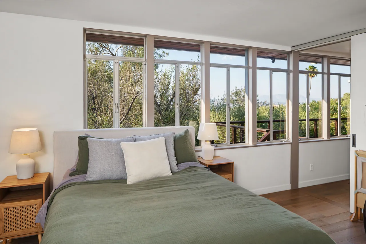 Bedroom 3 with windows toward the deck and trees