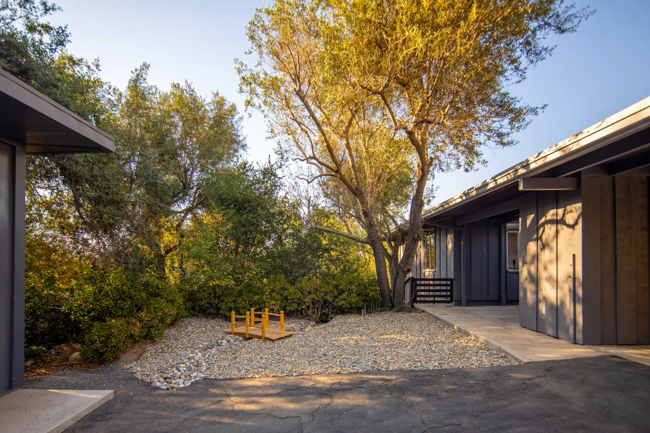 The breezeway opening toward the olive trees and office addition