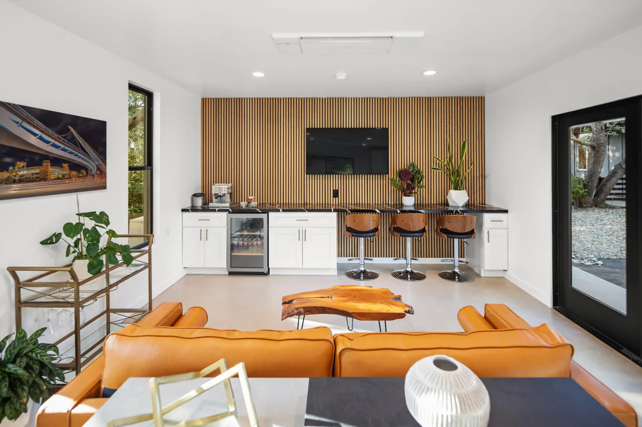 Office addition interior with a wood-slat feature wall and beverage bar