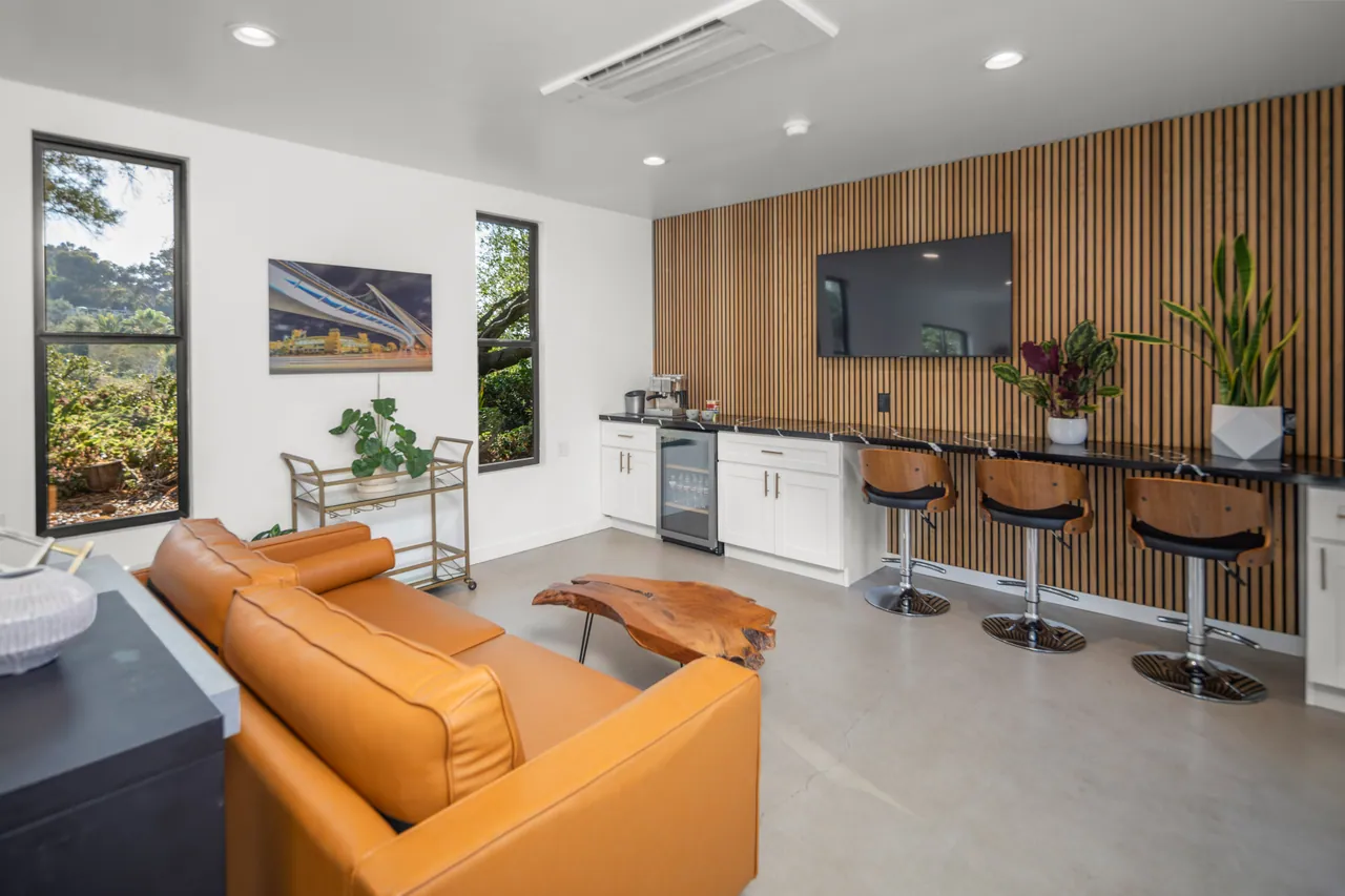 Office addition lounge area with built-ins and a flush-mount AC unit