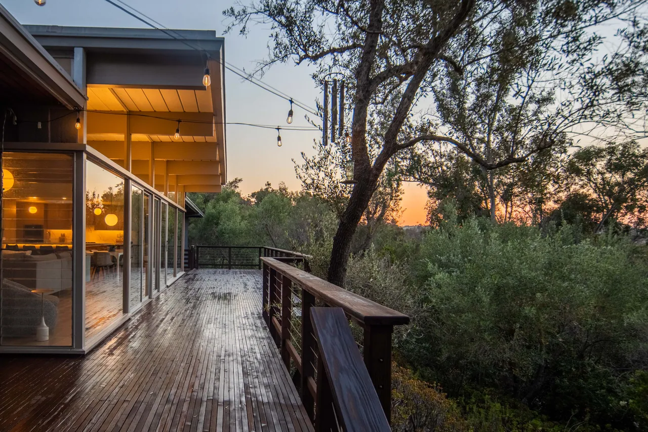 Deck and glowing interior at twilight