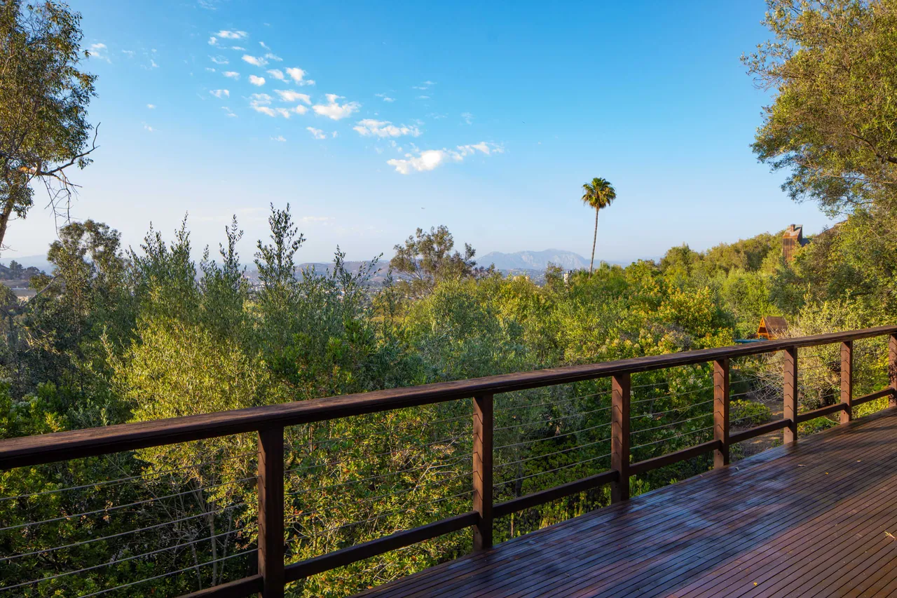 Deck railing overlooking the valley on a clear day