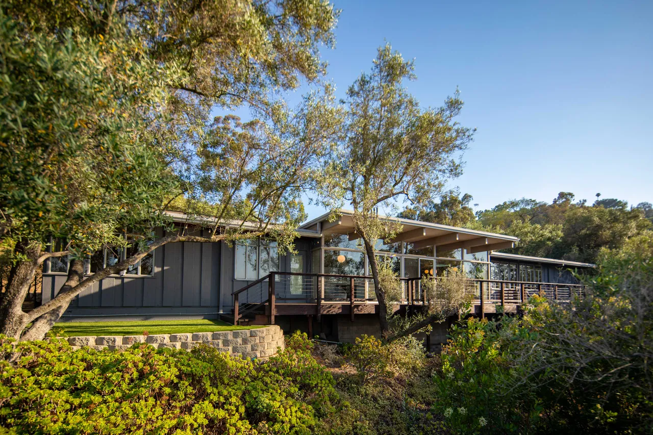 Rear of the house from below, with the deck and the green
