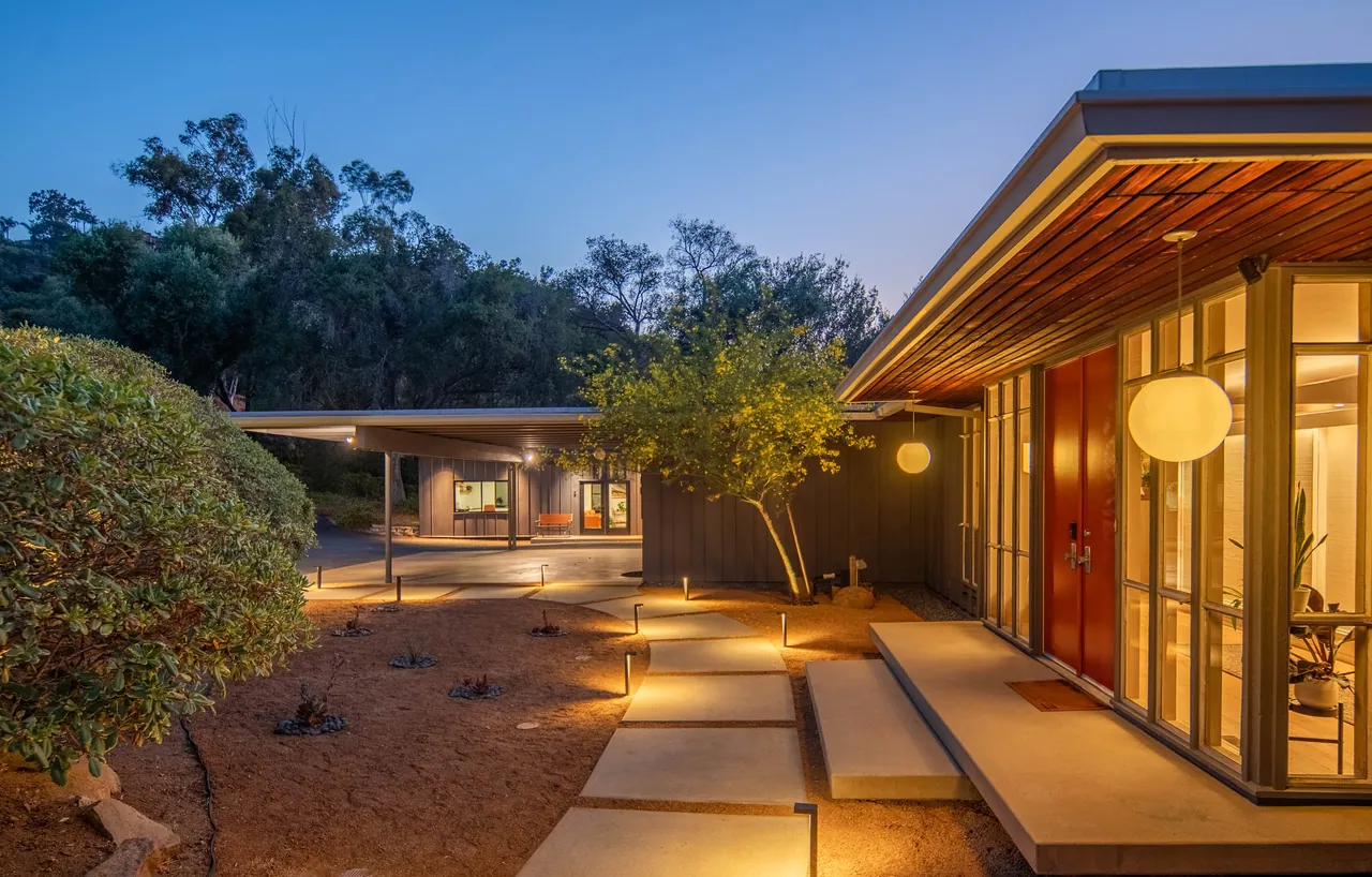 Entry court and carport at twilight with path lighting